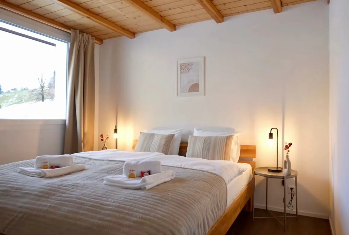 Bedroom with a large double bed and Schafberg view